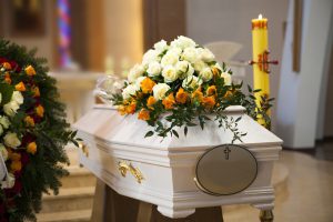a white coffin with flowers